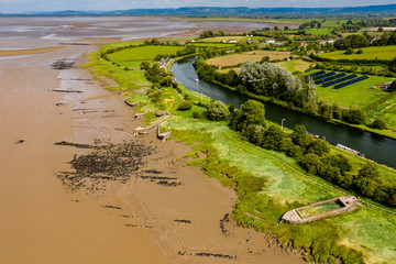 Aerial drone view of abandoned ships on the banks of the River Severn at Purton in England