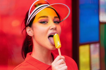 Young sexy brunette eating ice cream at hot day. seductive provocative woman