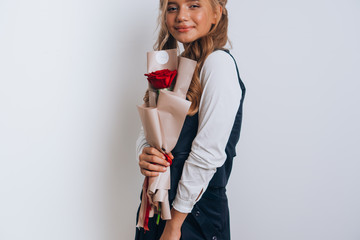Schoolgirl posing with a bouquet of flowers. Girl in a school suit. Day of Knowledge. September 1.