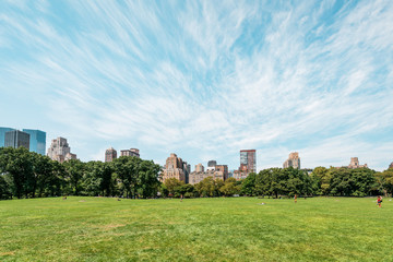 New York City/ Manhattan, NYC/ USA - 08 21 2017: Central Park on a sunny day with some clouds over...