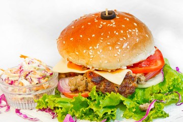 A big size Burger Patties from Ground Beef with Lettuce leaf and Coleslaw Salad.