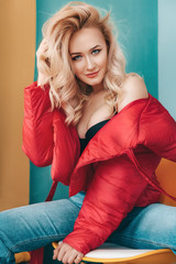 Portrait of beautiful young blonde woman with makeup in fashion clothes