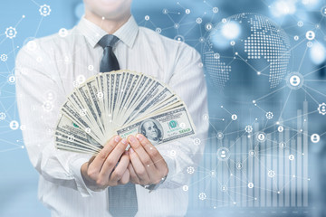 Businessman showing earned cash .