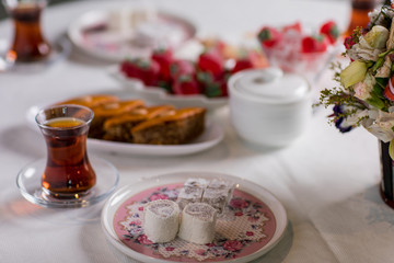 tea table. There are baklava, salmon, and other sweets on the table