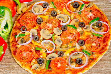 Popular colorful ingredients as like tomatoes, cheese, mushroom, capsicum, olives and other ingredients baked healthy Pizza.
