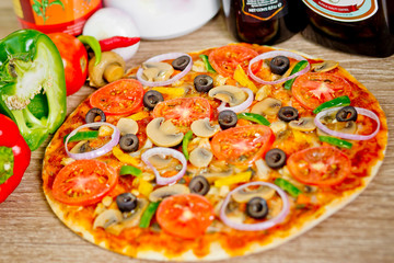 Popular colorful ingredients as like tomatoes, cheese, mushroom, capsicum, olives and other ingredients baked healthy Pizza.
