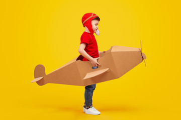 Little aviator in cardboard plane