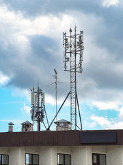 Fototapeta na wymiar Communication antennas on the roof against the sky.
