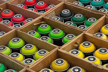 Graffiti spray paint cans in cardboard boxes