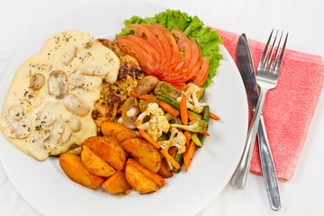 Peri peri Chicken with Button mushroom gravy, Saute Vegetables, Spicy fried Potatoes with Tomato Lettuce Salad.
