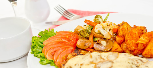 Peri peri Chicken with Button mushroom gravy, Saute Vegetables, Spicy fried Potatoes with Tomato Lettuce Salad.