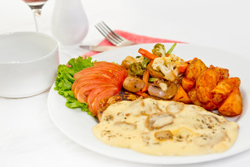 Peri peri Chicken with Button mushroom gravy, Saute Vegetables, Spicy fried Potatoes with Tomato Lettuce Salad.