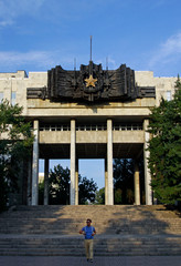Young man in front of the WW2 monument in Almaty, Kazakhstan