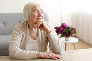 Senior woman relaxing to end headache. Shallow DOF.