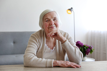Senior woman relaxing to end headache. Shallow DOF.