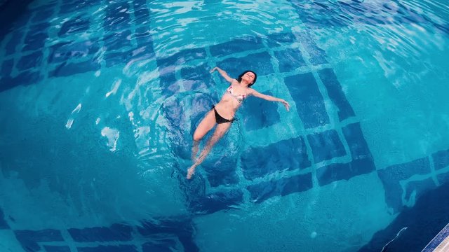 Aerial view of lying on water surface in big swimming pool