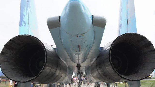 Russian fighter jet engine exhaust close up view, SU-27 Flanker tail section view, tilt down handheld shot