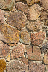 Vertical stonewall background. Big decorative stones and boulders. Close-up detail view.