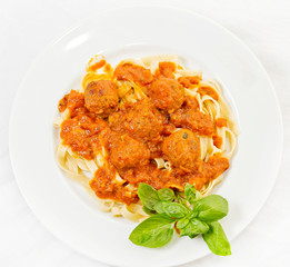 A plate of Fettuccine and Meatballs Pasta with Tomato Sauce.