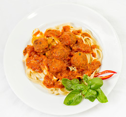 A plate of Fettuccine and Meatballs Pasta with Tomato Sauce.