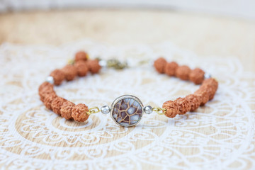 Mother pearl natural bead rudraksha seed bracelet on decorative background