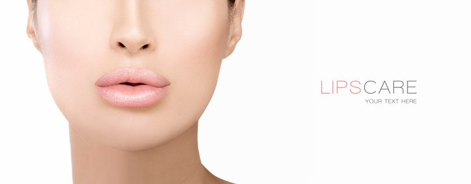 Plump lips of a beautiful woman. Nude lipstick. Care and beauty products