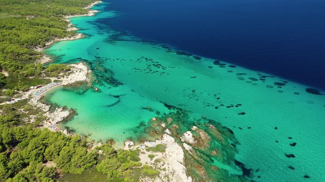 Aerial drone video of iconic turquoise paradise rocky beach of Kavourotripes in Sithonia Peninsula, Halkidiki, North Greece