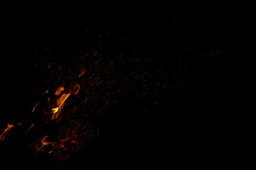 flame and sparkles orange natural illumination on black wallpaper pattern background with empty space for copy or text