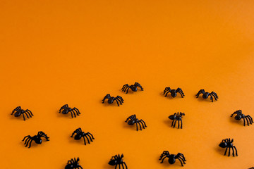 Halloween background. Spiders on an orange background. Place for text.