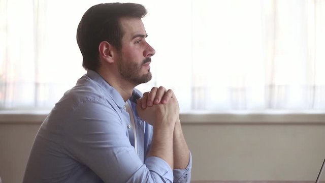 Entrepreneur sitting near laptop having business problems feels stressed