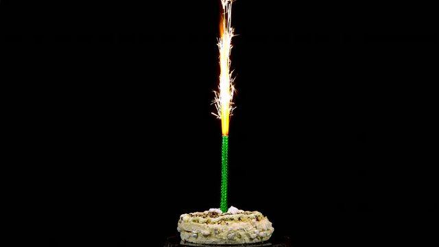 Holiday cake with fireworks on an isolated black background