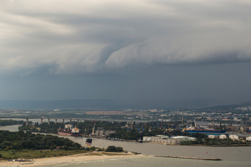 The city of Varna during the storm. The downpour is approaching the sea coast. The Bulgarian resorts in the summer. European recreation area. Thunderhead covers the city. 