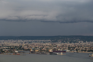 The city of Varna during the storm. The downpour is approaching the sea coast. The Bulgarian resorts in the summer. European recreation area. Thunderhead covers the city. 