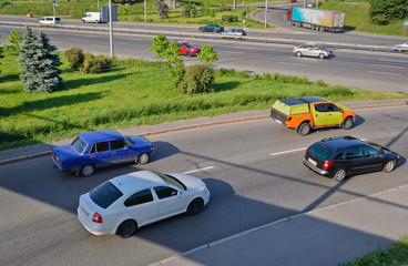 Road scene. Passenger cars moving on the road. Kyiv. Ukraine.