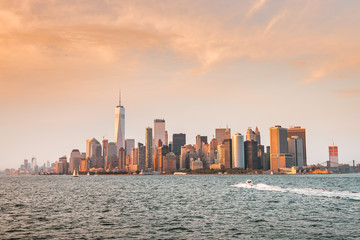 Fototapeta na wymiar New York City New Jersey, NYC/ USA - 08 21 2017: Amazing sunset on New York City Hudson River on public transport staten island ferry with beautiful panorama view to NYC Manhattan skyline
