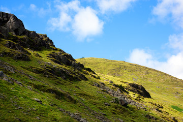 green hills against a blue sky