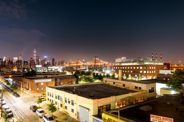 Long island City, New York City/ USA - 08 21 2017: View to the Queensboro Bridge in LIC NYC Big Apple at an bright night sky with skyscrapers and the amazing skyline of Manhattan in background