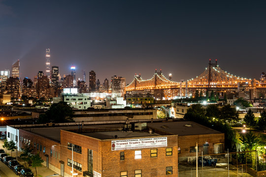 Long island City, New York City/ USA - 08 21 2017: View to the Queensboro Bridge in LIC NYC Big Apple at an bright night sky with skyscrapers and the amazing skyline of Manhattan in background