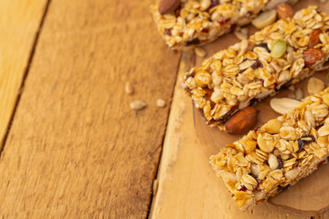 Obraz na płótnie Canvas granola bars on a wooden background with space for design, horizontal photo
