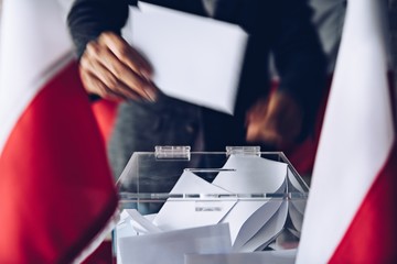 Man putting his vote do ballot box. Political elections