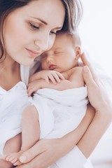 Young happy mother with baby girl