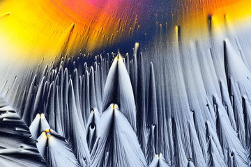 Colorful micro crystals in polarized light. Photo through a microscope.