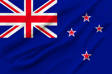beautiful photograph of the New Zealand national flag on delicate shiny silk with soft draperies, the concept of state power, country life, horizontal, close-up, copy space