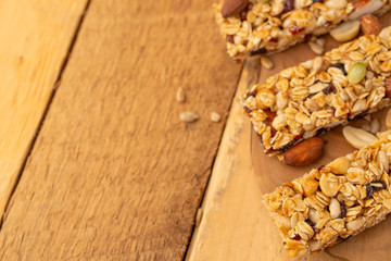 granola bars on a wooden background with space for design, horizontal photo