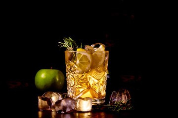 Red cocktail with lemon slice and Apple