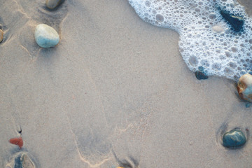 wet pebbles on the beach and water