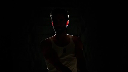 Portrait of handsome muscular man with sword.