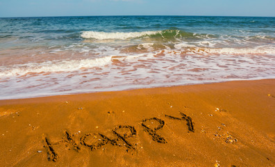 summer sandy sea beach with happy word on a sand