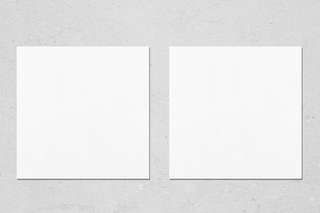 Two empty white square flyer or business card mockups with soft shadows on neutral light grey...