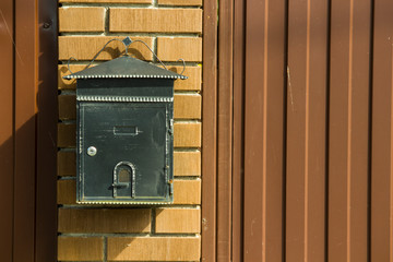 letter box on a metal fence in the daytime in summer
